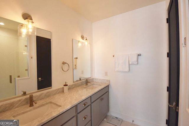 bathroom with vanity, a shower with shower door, and tile patterned flooring