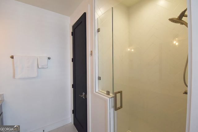 bathroom featuring a shower with shower door