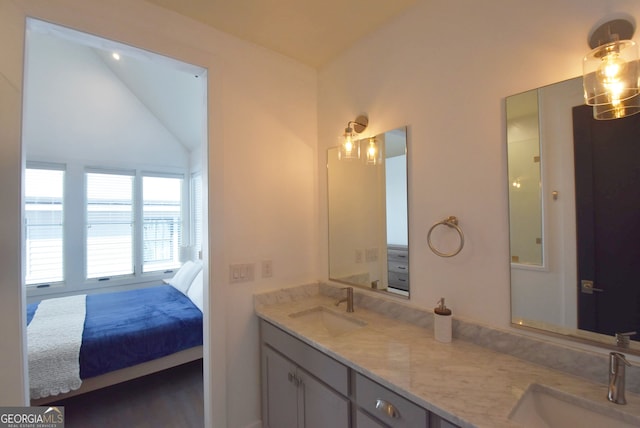 bathroom featuring vanity and vaulted ceiling