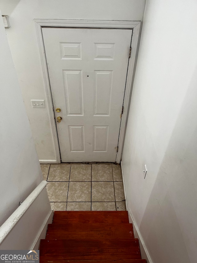 doorway to outside with light tile patterned floors