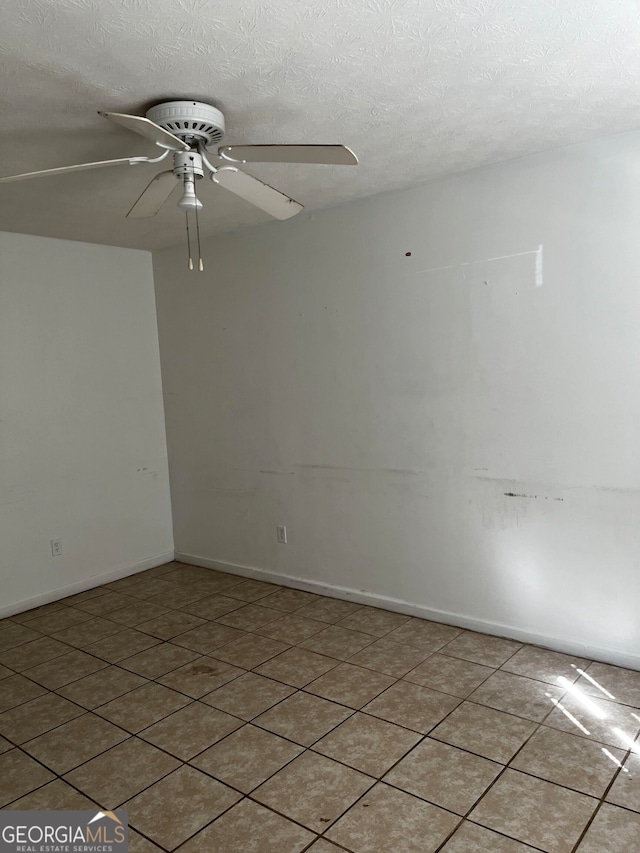 spare room featuring a textured ceiling and ceiling fan