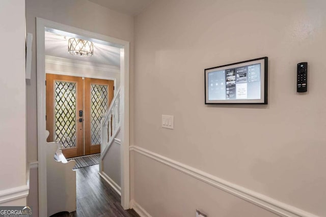 entrance foyer with ornamental molding, french doors, and dark hardwood / wood-style floors