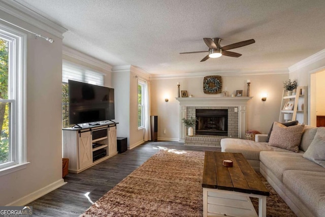 living room with ornamental molding, dark wood-type flooring, ceiling fan, and plenty of natural light