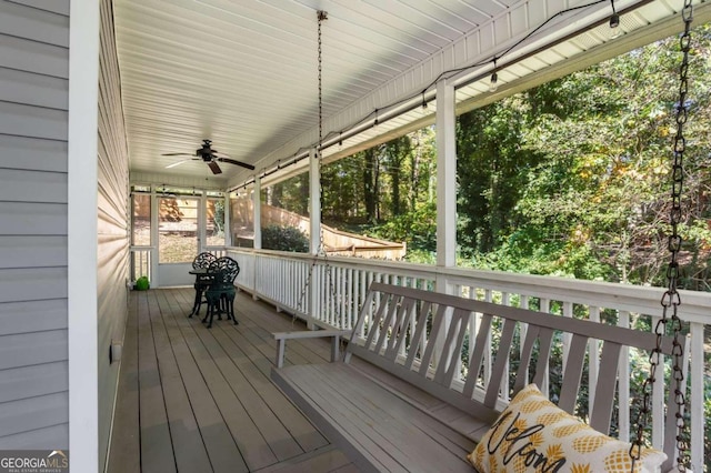 wooden deck featuring ceiling fan