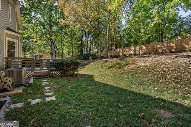 view of yard featuring a wooden deck and central air condition unit