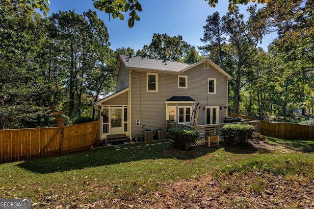 rear view of property with a lawn