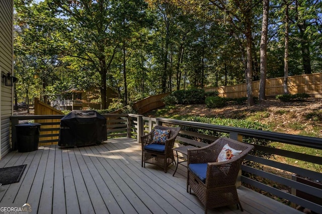 wooden deck featuring a grill