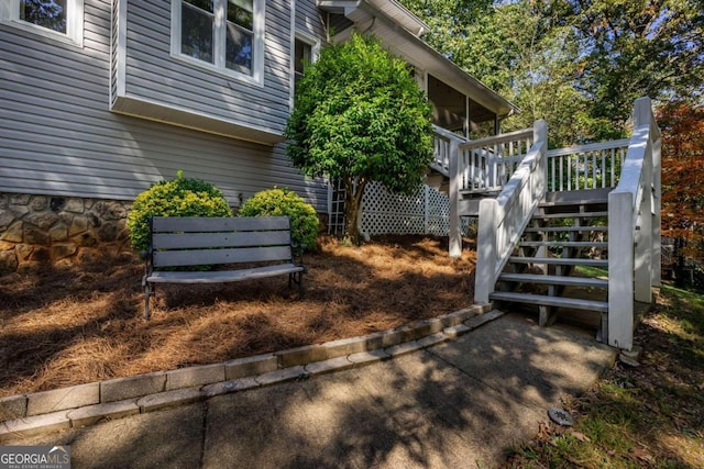 view of property exterior featuring a wooden deck