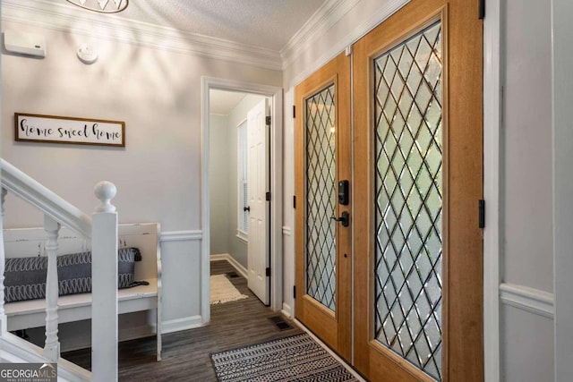 foyer entrance featuring french doors, ornamental molding, a textured ceiling, and dark hardwood / wood-style floors