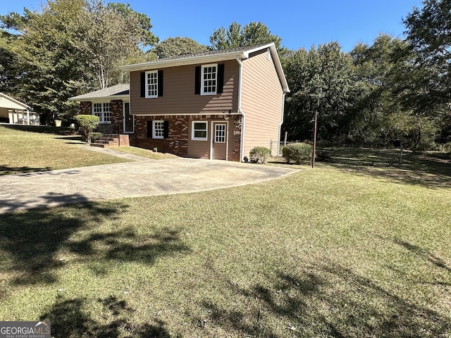 back of property featuring a patio and a yard