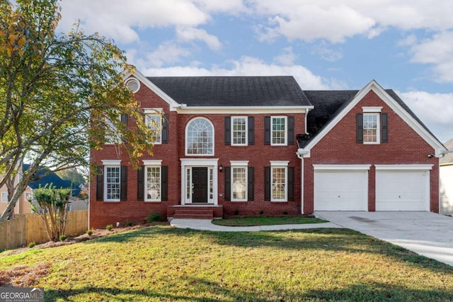 colonial home with a front yard and a garage