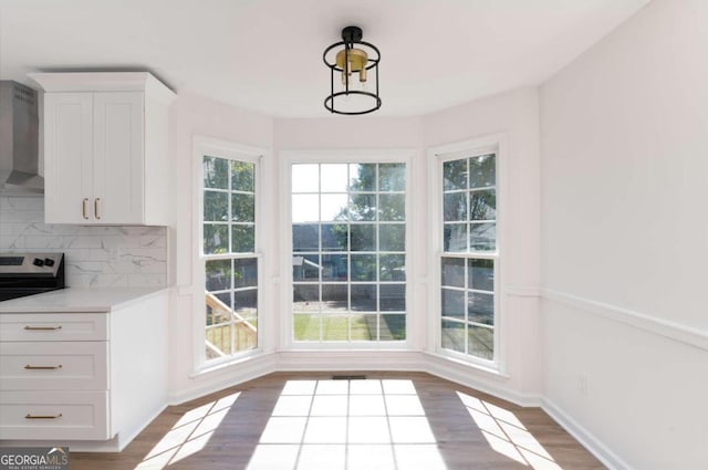 unfurnished dining area featuring hardwood / wood-style flooring