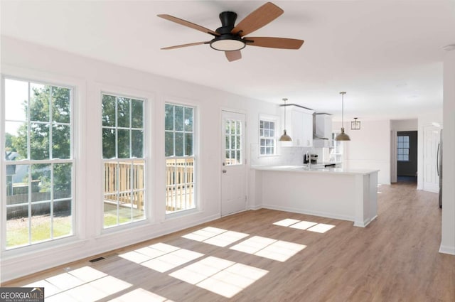 interior space with light hardwood / wood-style flooring and ceiling fan