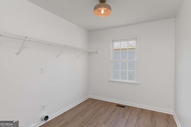 laundry area with electric dryer hookup and hardwood / wood-style floors