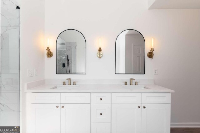 bathroom featuring vanity and a shower with shower door