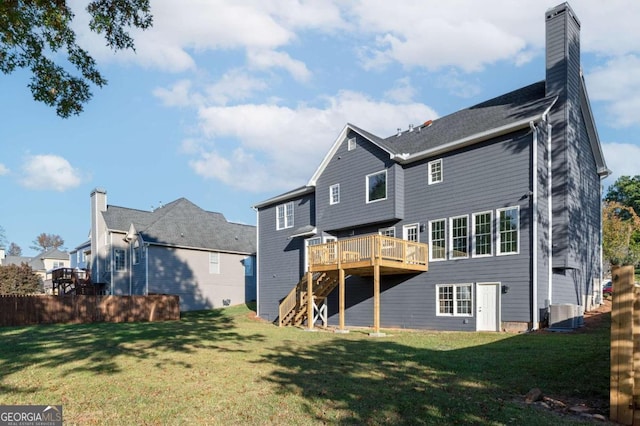 back of property featuring a yard and a deck