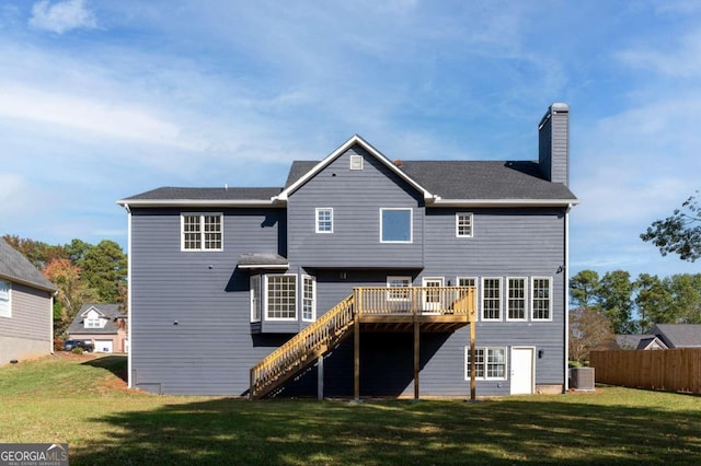 rear view of house featuring central AC, a deck, and a yard