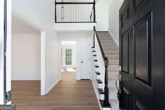 entrance foyer featuring hardwood / wood-style flooring and ornamental molding