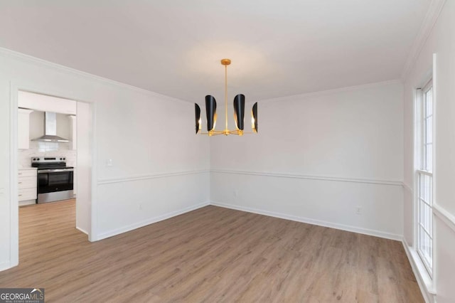 unfurnished dining area with light hardwood / wood-style flooring, ornamental molding, and a notable chandelier