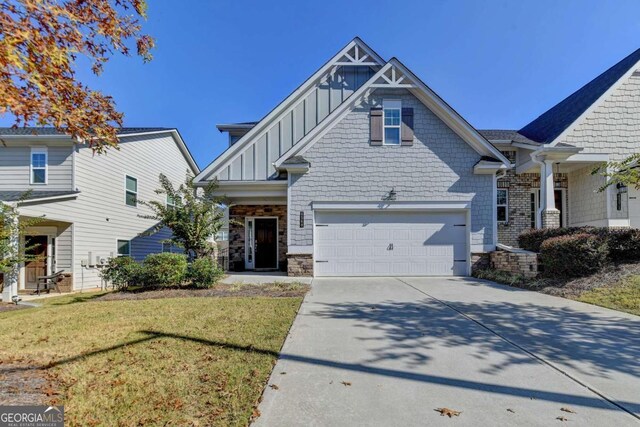 craftsman-style house with a garage and a front lawn