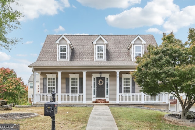 view of front of home with covered porch and a front lawn