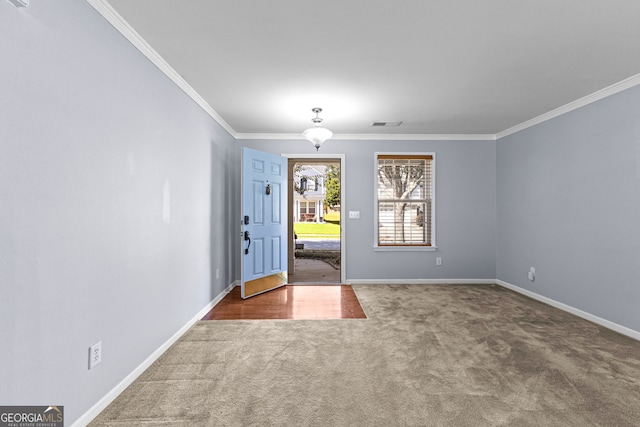 entrance foyer featuring crown molding and carpet flooring