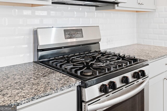 details with white cabinetry, light stone counters, gas stove, and tasteful backsplash