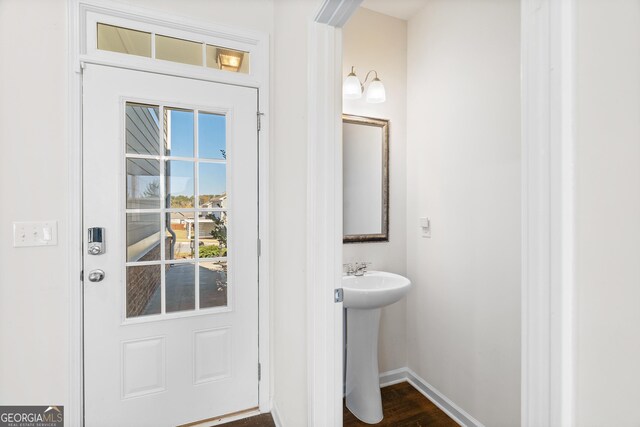 doorway with dark wood-type flooring