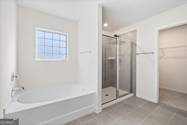 bathroom featuring independent shower and bath and tile patterned flooring