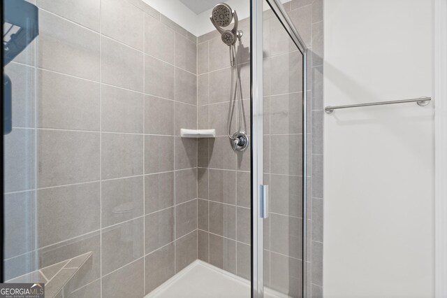 bathroom with a shower with door