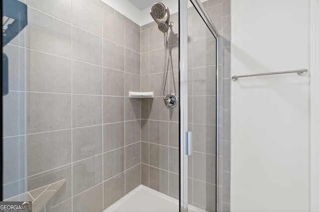 bathroom with tiled shower