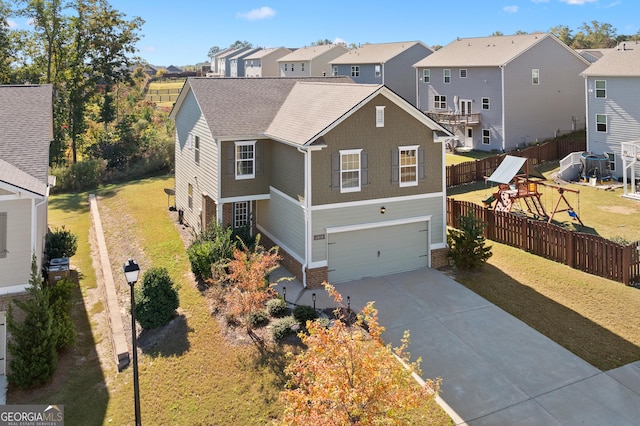 front facade featuring a garage, a playground, and a front lawn