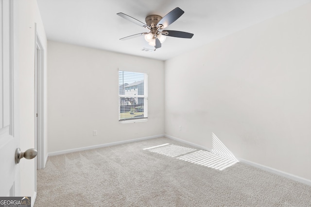 unfurnished room featuring light carpet and ceiling fan