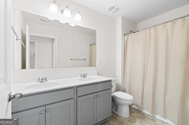 bathroom featuring vanity, toilet, and a shower with shower curtain