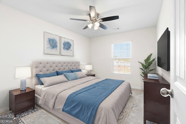 bedroom featuring light carpet and ceiling fan