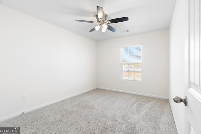 empty room with ceiling fan and carpet floors