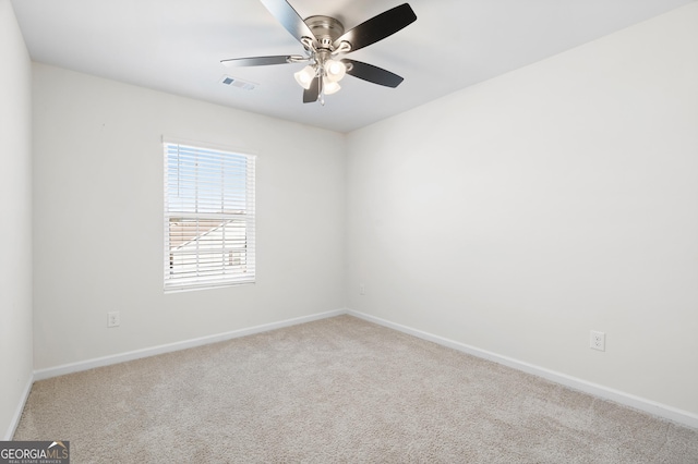 carpeted spare room featuring ceiling fan