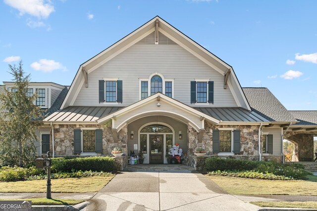 view of front of property with french doors and covered porch