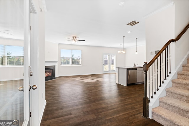 living room featuring dark wood-type flooring, ceiling fan, ornamental molding, and sink