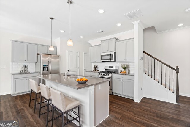 kitchen with decorative light fixtures, stainless steel appliances, backsplash, and dark hardwood / wood-style flooring