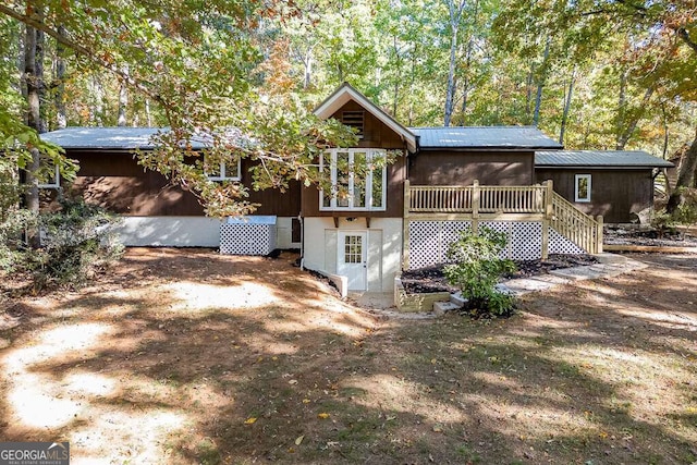 rear view of property with a wooden deck