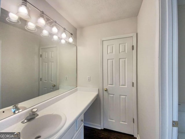 bathroom featuring vanity, a textured ceiling, and hardwood / wood-style floors