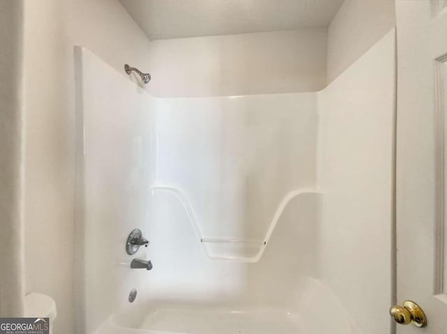 details featuring washtub / shower combination