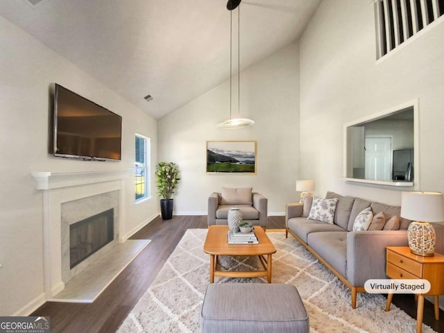 living room with hardwood / wood-style flooring and high vaulted ceiling