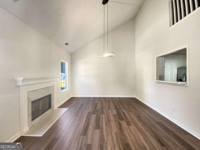 unfurnished living room featuring dark hardwood / wood-style floors, high vaulted ceiling, and a high end fireplace