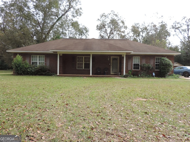 ranch-style home featuring a front yard