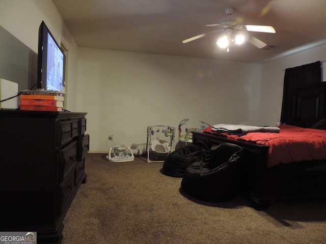 bedroom featuring ceiling fan and dark colored carpet