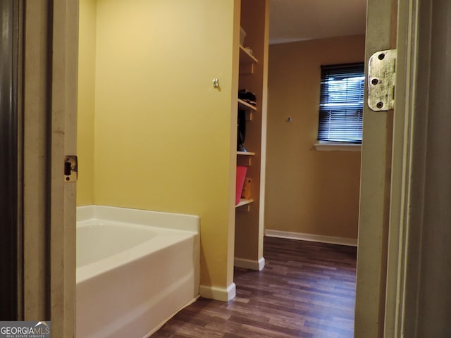 bathroom featuring a tub to relax in and hardwood / wood-style flooring