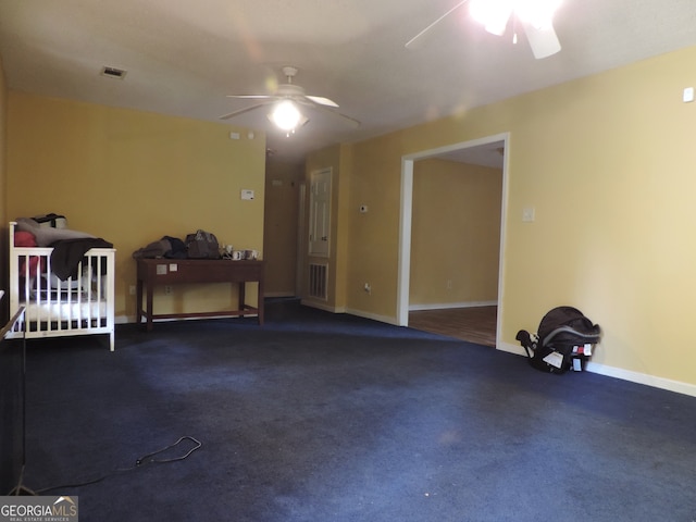 carpeted empty room featuring ceiling fan