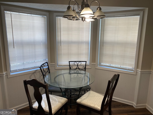 dining area featuring a notable chandelier and dark hardwood / wood-style floors